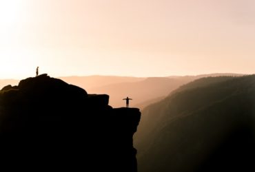 Man standing on a mountain before the abysm.