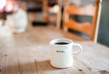 A cup of coffee with a label named "BEGIN."